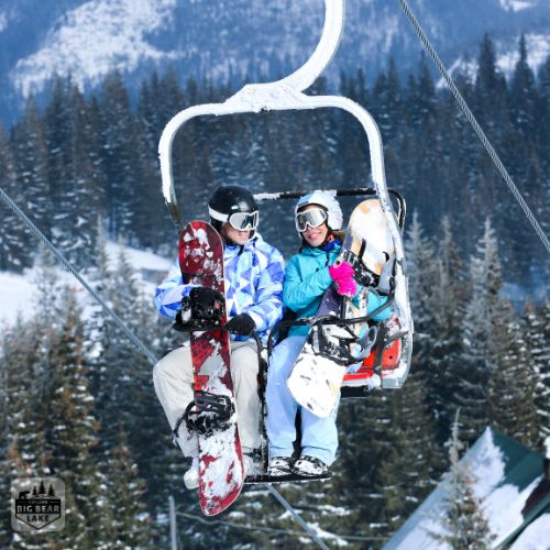 snowboarding couple on ski lift at Bear Mountain Ski resort in Big Bear