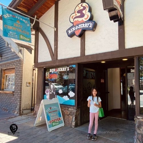 Exterior of Ben and Jerry’s Big Bear ice cream shop in Big Bear Village with guest holding an ice cream cone