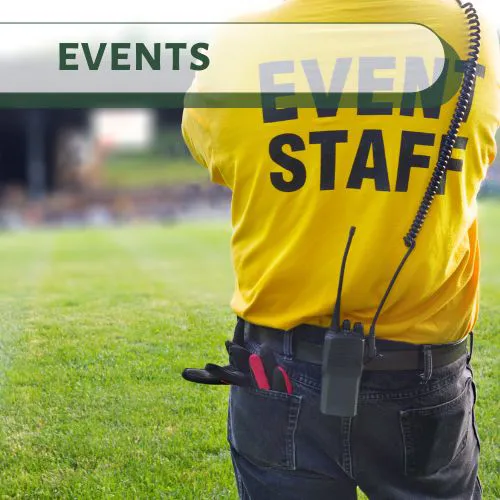 Event staff in yellow shirt preparing for a community event in Big Bear Lake.
