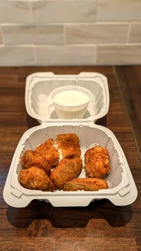 Six crispy jalapeño poppers served with a generous portion of ranch dressing from Maggio's Pizza in Big Bear, California